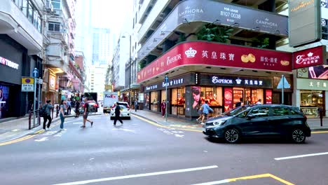 vehicles and pedestrians at a bustling city corner