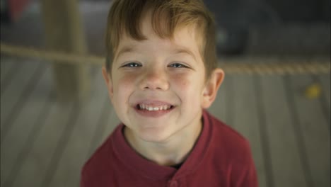 Closeup-of-happy-little-boy-smiling-at-halloween-pumpkin-patch