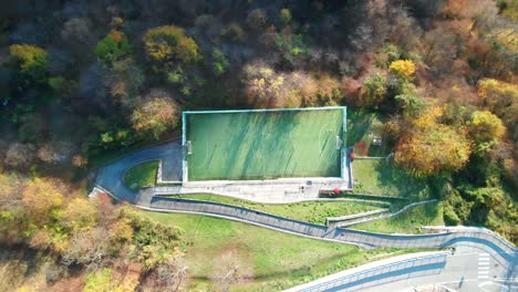 cinematic-drone-shot-over-a-football-field-in-an-old-town-in-northen-italy