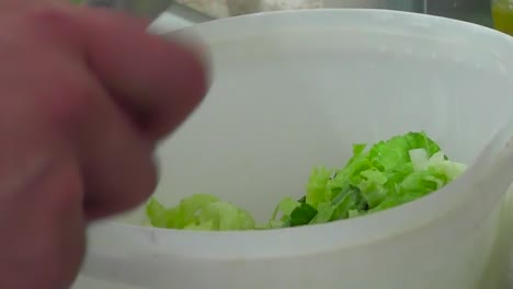 preparing lettuce salad