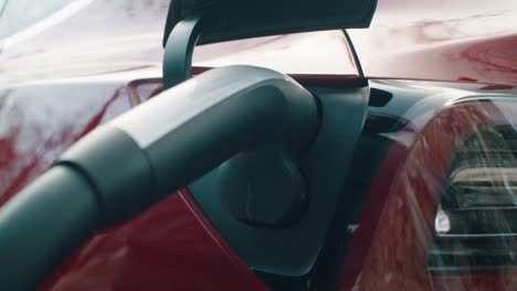 Close up of plugging the charging cable into the electric car