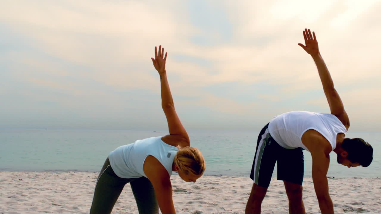 Friends stretching on the beach