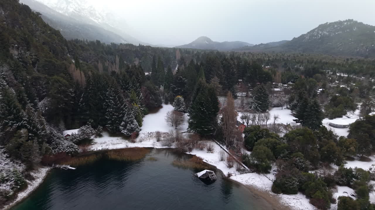 Snowy aerial landscape of Perito Moreno Lake and suburb area with surrounding forest and mountains, Bariloche, Argentina