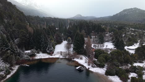 snowy aerial landscape of perito moreno lake and suburb area with surrounding forest and mountains, bariloche, argentina