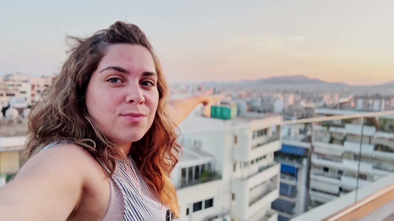 Woman Enjoying Sunset View of Athens from Balcony