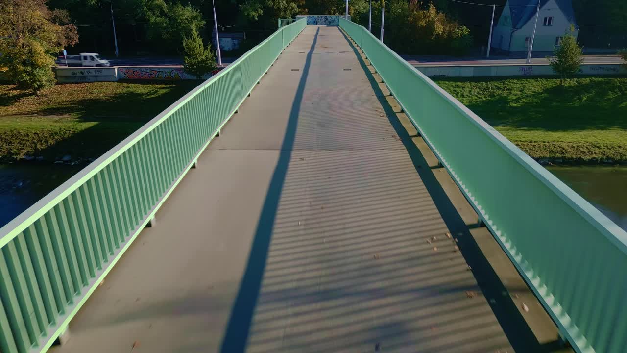 Drone Low reverse over footbridge reveals parallel linear perspective