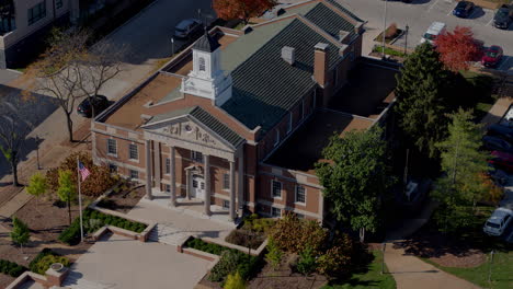 aerial of city hall in kirkwood, missouri in autumn with pull away