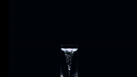 whirlpool in a glass of water on black background