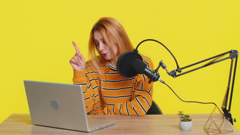 blogger woman influencer recording podcast giving workshop webinar speaking in microphone and laptop