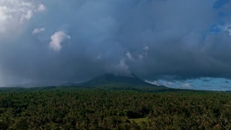 drone reveal of paco volcano amidst stormy skies in mainit, philippines