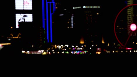 vibrant cityscape with illuminated buildings and ferris wheel