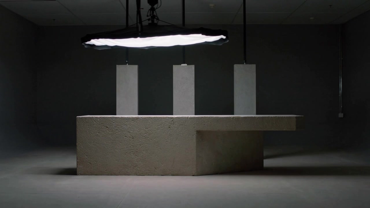 Shifting rig moving hanging light tilting across studio plinth with 3 slabs, showing right overhang