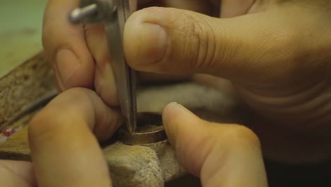 italian goldsmith at work building an engagement or a wedding ring