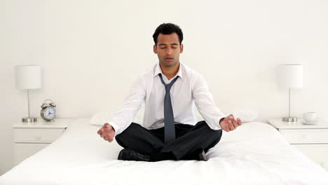 calm handsome businessman meditating