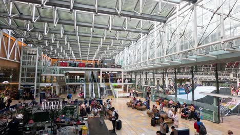 crowds and activities at paddington station, london