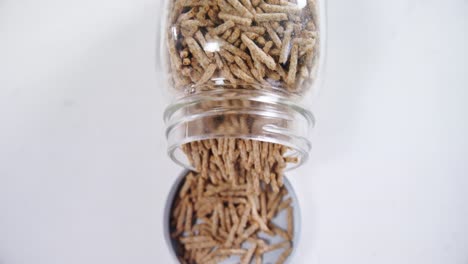 Cereal-bran-sticks-spilling-from-glass-jar-4k