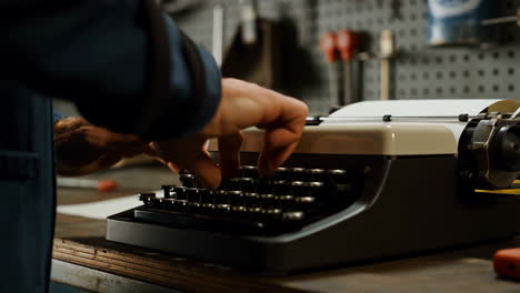 close-up of hands typing on a vintage typewriter
