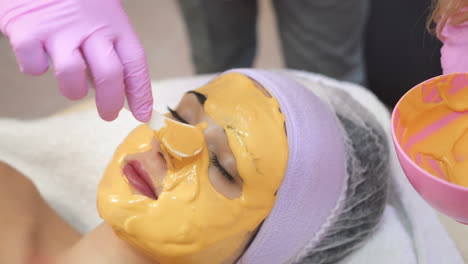 young woman gets beauty facial injections in salon. face aging, rejuvenation and hydration procedures. aesthetic cosmetology.