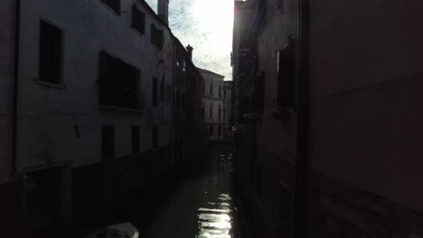 empty quiet waterways on the narrow street in venice, italy at dawn