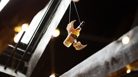 whiskey bottle suspended with wings in distillery