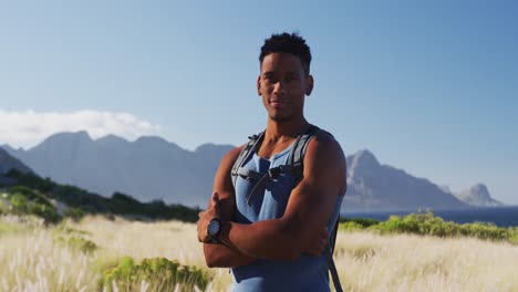 Portrait-of-african-american-man-cross-country-running-in-mountain-countryside-looking-at-the-camera