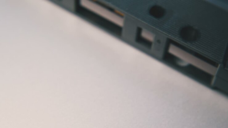 vintage compact cassette with tape on white background