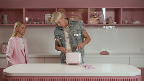 blond guy trying to repair an unplugged toaster