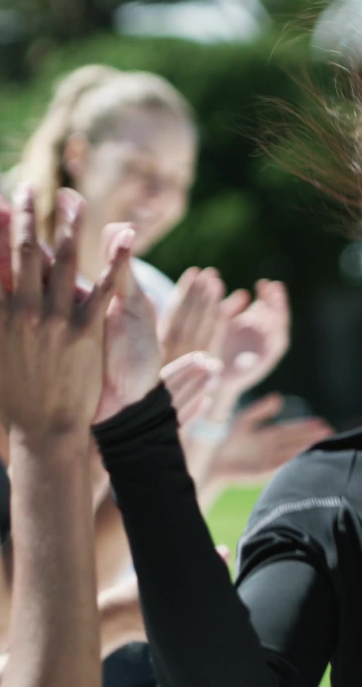 Group of Women Celebrating and High-Fiving After Outdoor Workout