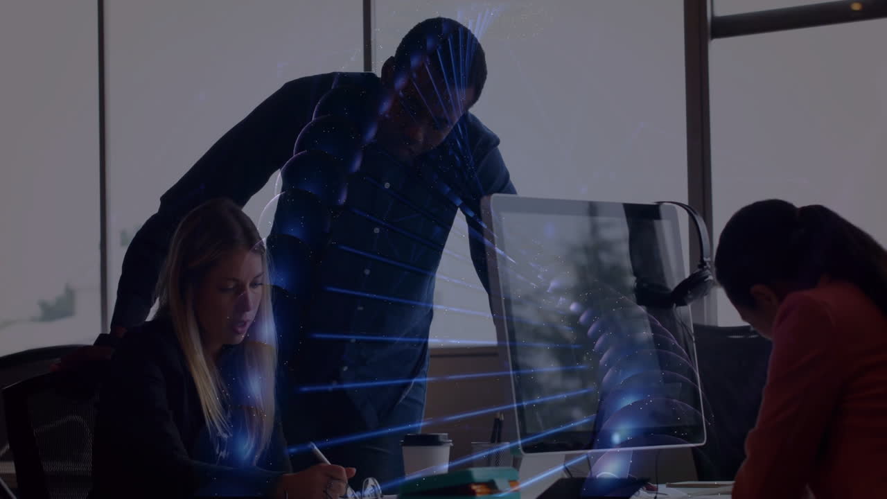 DNA strand animation over diverse business team working at office desk