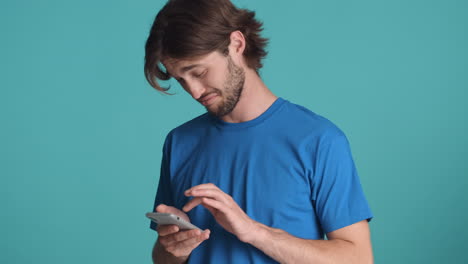 Caucasian-man-in-front-of-camera-on-blue-background.