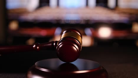 a close-up view of a gavel resting in a courtroom, representing justice, order, and legal authority