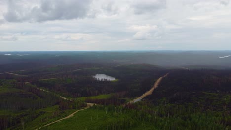 right-to-left-sliding-aerial-of-the-large-expanse-of-forested-lands-burnt-to-the-ground-in-Canada-during-a-massive-wildfire