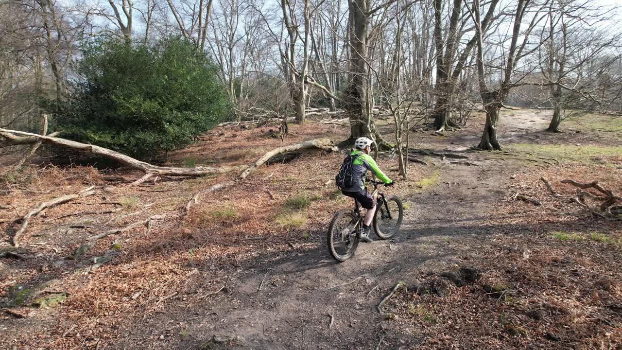 E Mountain bike hill climb Epping forest UK drone tracking though trees