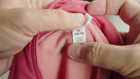 close-up of clothing tag on a pink shirt