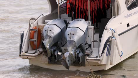 boat stranded on beach with damaged outboard engine propeller visible