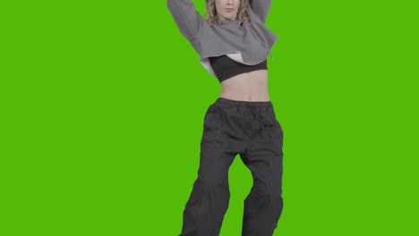 Close-Up-Studio-Shot-Of-Young-Woman-Having-Fun-Dancing-Against-Green-Screen-2