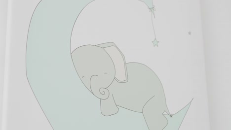 minimal nursery art of elephant resting on crescent moon