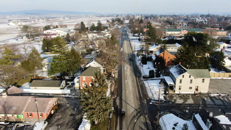 AERIAL-Dolly-Back-Along-Snowy-Winter-Township-Road