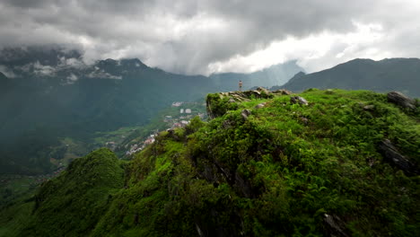 man stand on ham rong mountain overlooking scenic sapa town with karst mountains