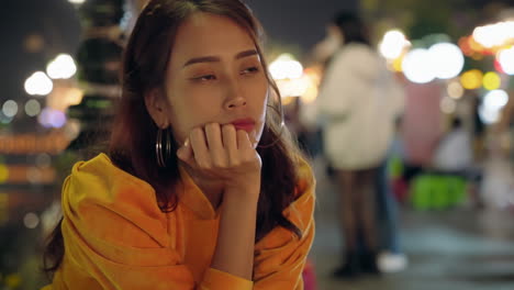 young vietnamese woman staring gawking at the side of the street