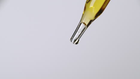 A-simple-pipette-dropper-with-yellow-liquid-and-a-bright-white-background