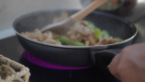 stir-frying food in a pan