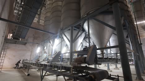 Industrial Factory Interior with Conveyor Belts and Silos