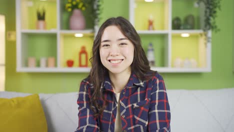 happy asian young woman winking.