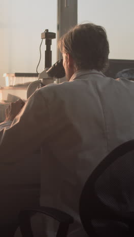 scientist using a microscope in a laboratory