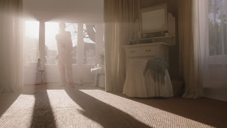 beautiful teenage ballerina girl practicing ballet dancing in bedroom rehearsing dance on weekend morning wearing pajamas at sunrise