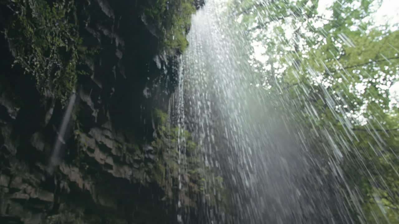 Waterfall cascading down a rock face in a forest