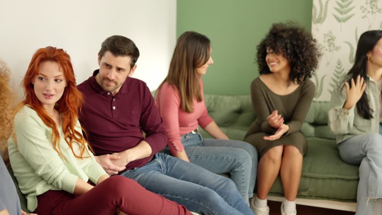 Group of friends talking sitting together in a sofa