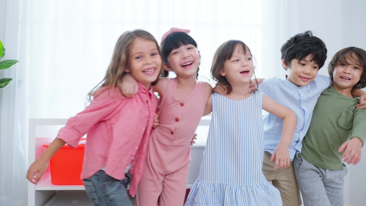 Mixed race Group of young children student playing together in school. Little preschool boy and girl kid feeling happy and fun while spend free time play toys during break in classroom at kindergarten