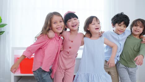 mixed race group of young children student playing together in school. little preschool boy and girl kid feeling happy and fun while spend free time play toys during break in classroom at kindergarten